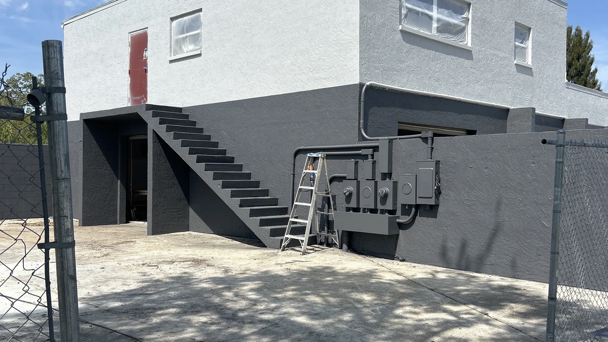 A freshly painted navy block home with white trim in Largo, Florida
