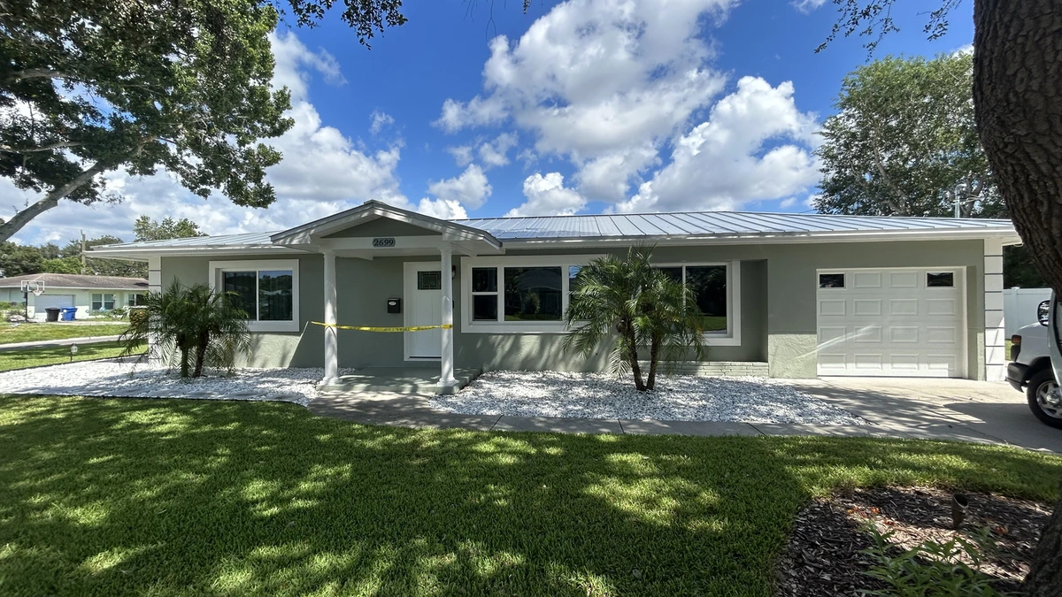 A freshly painted navy block home with white trim in Largo, Florida