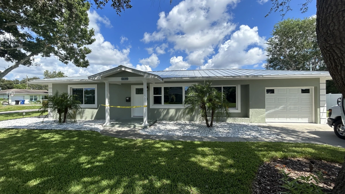 A freshly painted navy block home with white trim in Largo, Florida