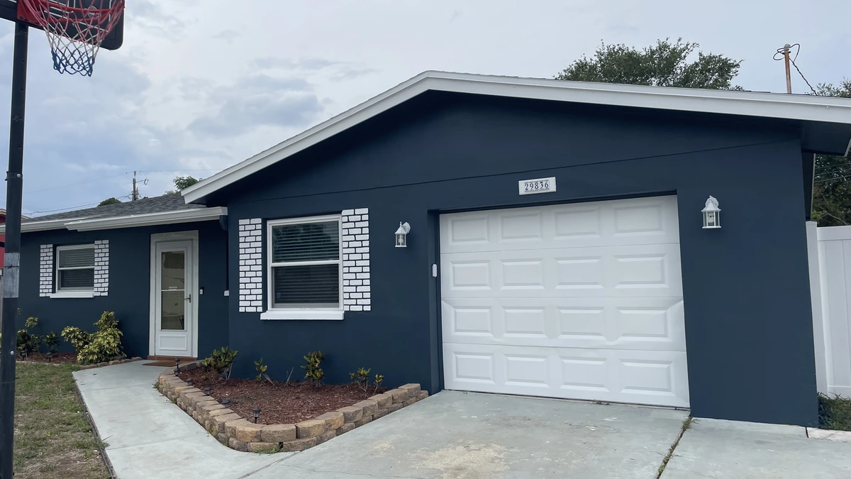 A freshly painted navy block home with white trim in Largo, Florida
