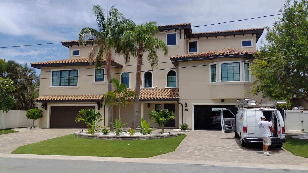A freshly painted navy block home with white trim in Largo, Florida